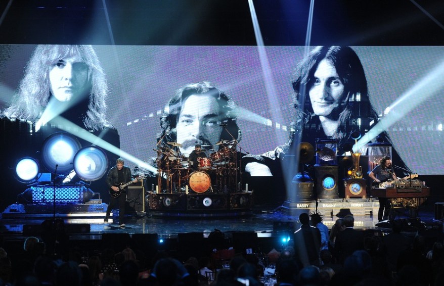 LOS ANGELES, CA - APRIL 18: (L-R) Inductee Alex Lifeson, Neil Peart, and Geddy Lee of Rush perform on stage at the 28th Annual Rock and Roll Hall of Fame Induction Ceremony at Nokia Theatre L.A. Live on April 18, 2013 in Los Angeles, California. (Photo by Kevin Winter/Getty Images)